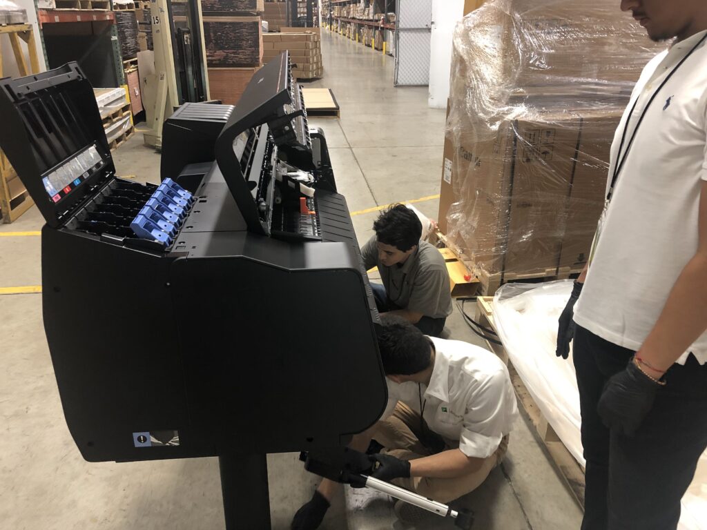 Technicians installing a Canon image PRO 4100 printer