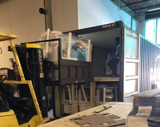 Loading a truck full of printers at the Miami Warehouse for shipping