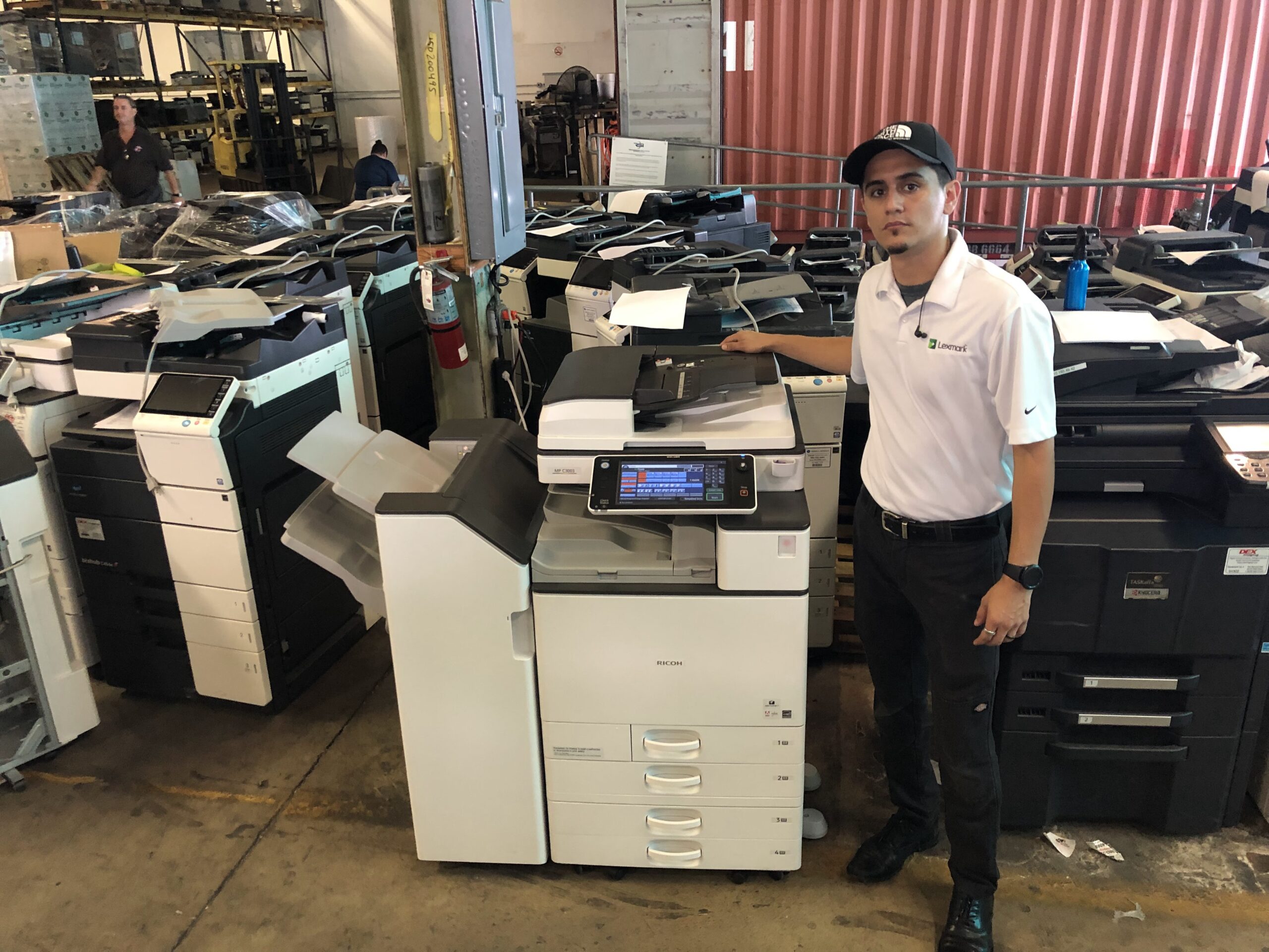 Victor Printing Systems technician with a Ricoh color printer